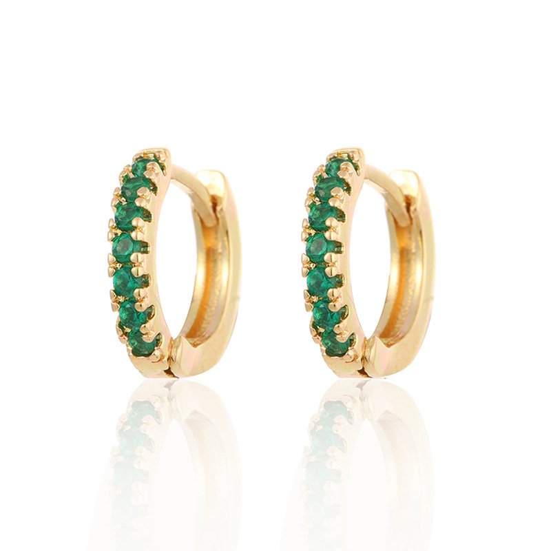 Gold Row Huggies Earrings adorned with emerald stones on white background - IceGlint