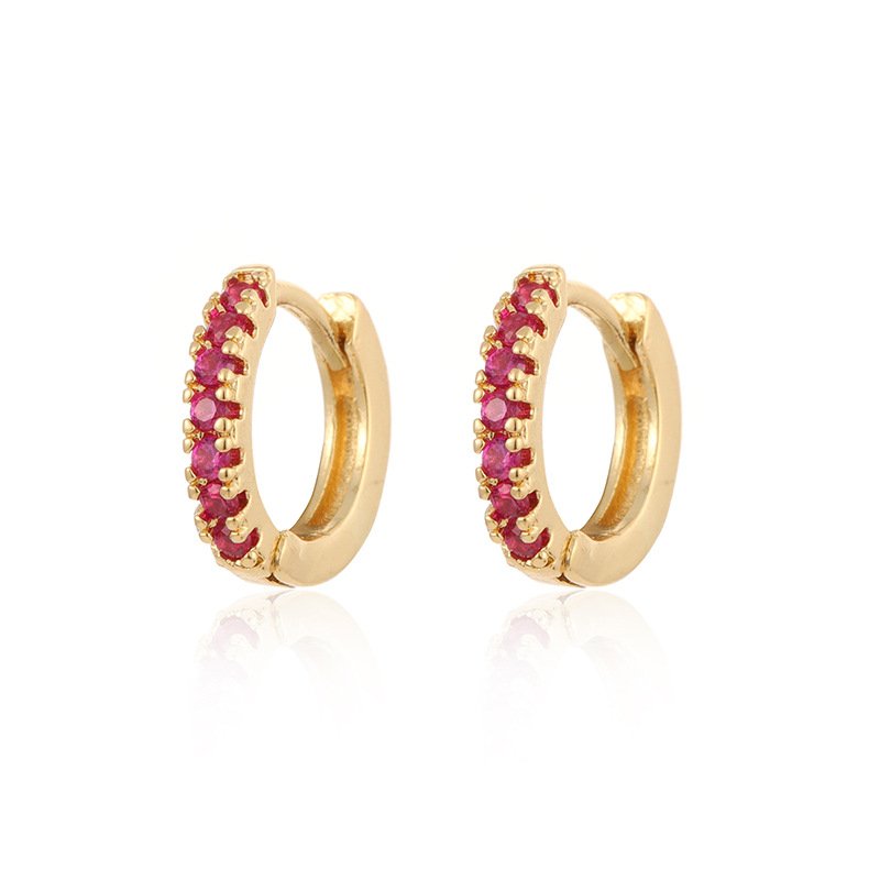 Gold Row Huggies Earrings featuring ruby stones on white background.