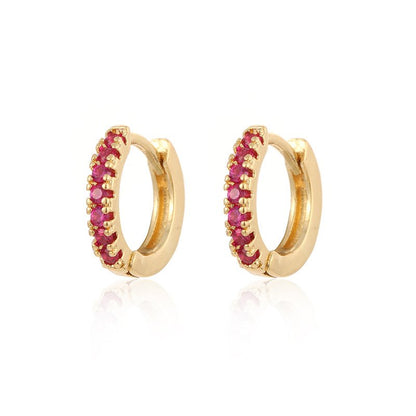 Gold Row Huggies Earrings featuring ruby stones on white background.